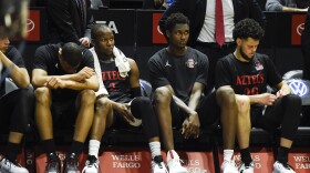 San Diego State players sit on the bench during the second half of an NCAA college basketball game against UNLV, Saturday, Feb. 22, 2020, in San Diego. UNLV won 66-63. 