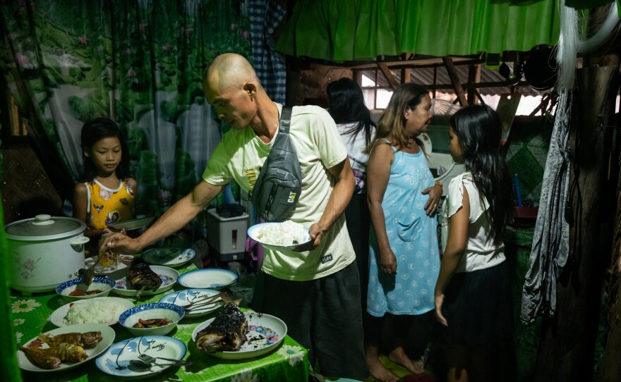 Vincent Gehisan, 36, enjoys a meal at his home in Quezon, Palawan, the Philippines, on May 24, 2025. Gehisan was hassled and detained for nearly a day at sea by Chinese Coast Guard and navy ships while out on a resupply mission the year before and now says he's afraid to venture far from Filipino shores to fish.