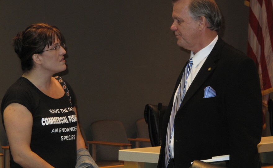 Florida state Rep. Doug Broxson (R-Gulf Breeze) listens as Kathryn Birren, owner of Hernando Beach Seafood, expresses her frustration with the claims process in the aftermath of the BP oil spill. She says business is down about 70 percent in her family's commercial fishing operation.