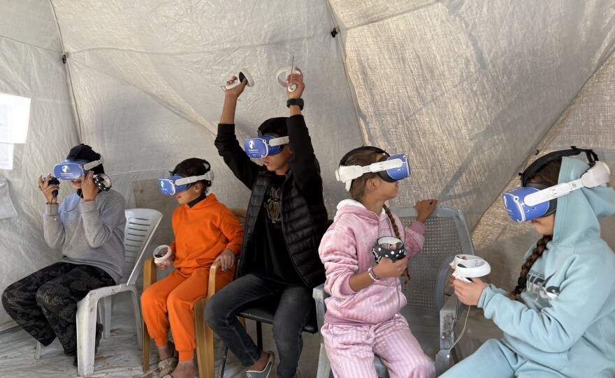 Children wear virtual reality headsets as part of a TechMed Gaza initiative that aims to help provide children with psychosocial support for trauma, in Al-Zuweida, Gaza, on Dec. 10, 2025.
