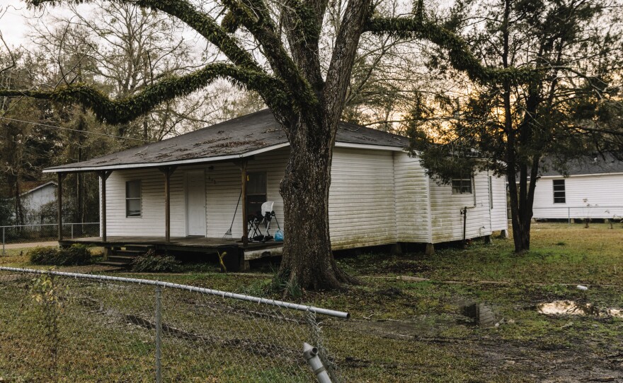 The sun sets behind a residential home in downtown Oakdale.