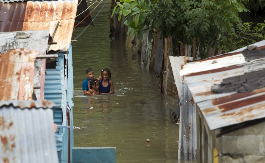 Streets were inundated in a neighborhood in Santo Domingo, Dominican Republic, on Tuesday. Hurricane Matthew dumped rain across the island of Hispaniola, which is split into the Dominican Republic in the east and Haiti to the west.