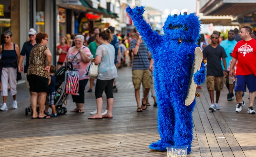 A Cookie Monster is one of many costumed performers on the boardwalk in Ocean City, Md., this summer. Kids can pose for a photo with them and then their parents are expected to leave a tip.