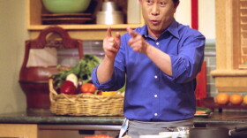 Promotional photo of Martin Yan cooking in the kitchen