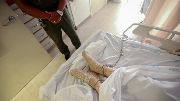 A correctional officer keeps watch over a prisoner in an undisclosed California medical facility near San Francisco on May 18, 2021.