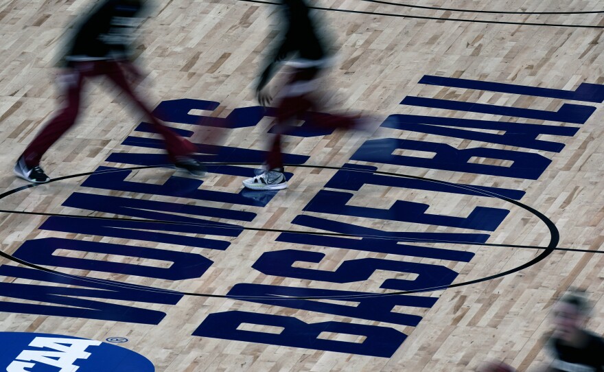 Stanford players, top, and a Utah Valley player warm up before their college basketball game in the first round of the women's NCAA tournament at the Alamodome in San Antonio, in this March 21, 2021, file photo. The NCAA women's basketball tournament used March Madness in marketing and branding this season.