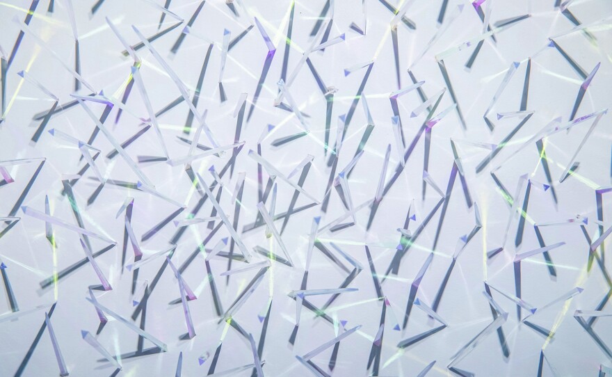Kaori Fukuyama's "Murmuration" is a 54" x 58" x 5" installation work of clear plastic picks and dichroic film, on view at PHES Gallery through Jul. 30, 2022.