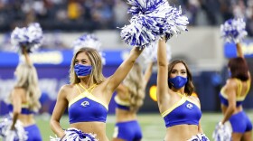 Cheerleaders wearing face masks perform prior to a preseason NFL football game between the Los Angeles Rams and the Los Angeles Chargers Saturday, Aug. 14, 2021, in Inglewood, Calif.