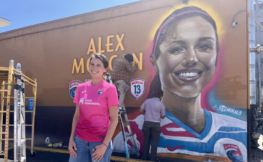Sirens Supporter Group member Amanda Farr stands in front of a new Alex Morgan mural in North Park, Sept. 5, 2025.