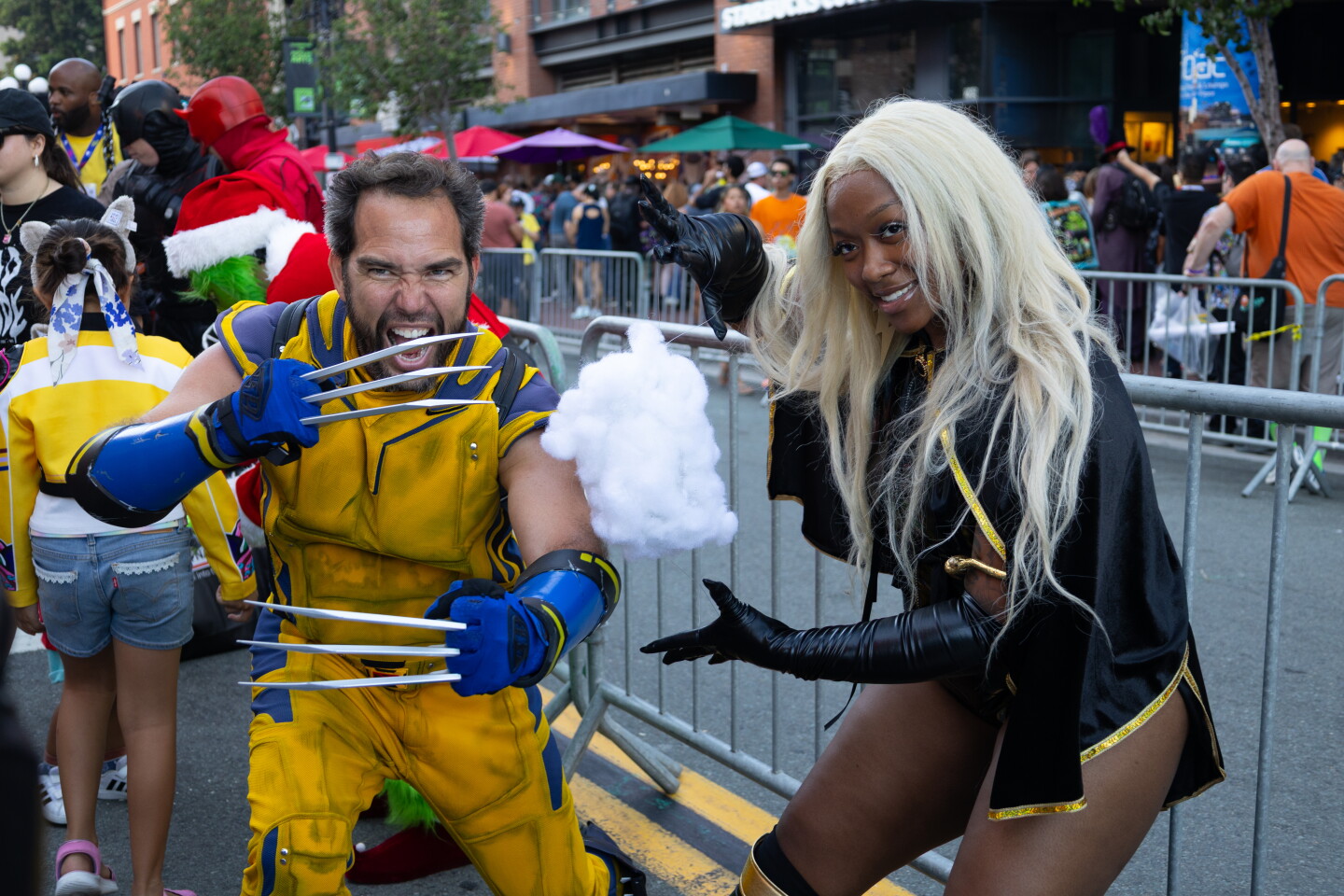 Wolverine and Storm cosplayers pose in character at Comic-Con on July 24, 2026.