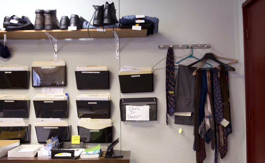 Work and interview clothes hang in the Reentry Transition Center office, available as needed for program participants.