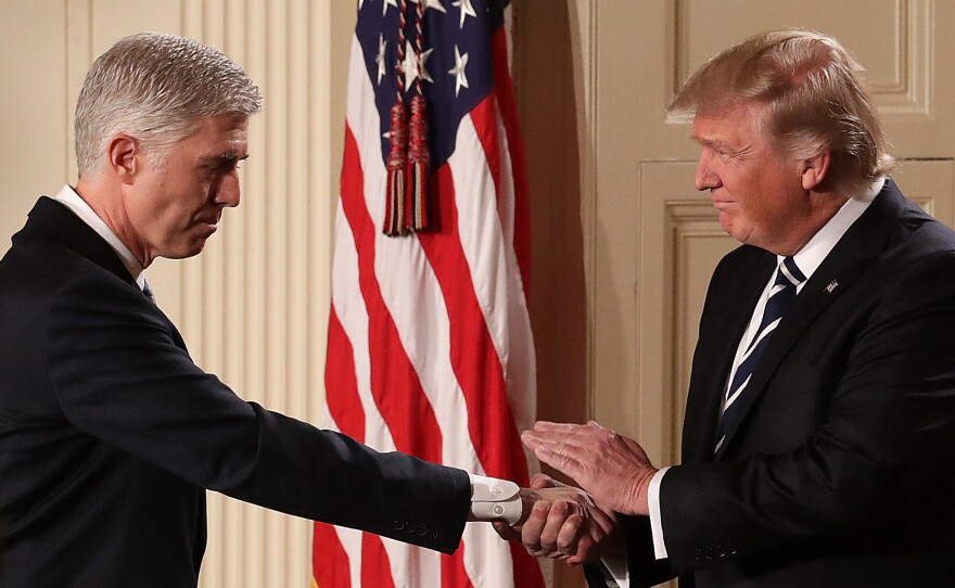 President Trump shakes hands with Judge Neil Gorsuch after nominating him to the U.S. Supreme Court during a ceremony in the East Room of the White House on Tuesday in Washington, D.C.