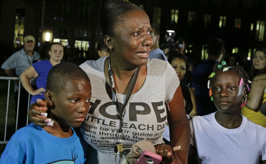 Darrsie Jackson keeps her children — Linzey Stafford, left, 10, and Shauntina Stafford, 11 — close after hearing the verdict of not guilty in the trial of George Zimmerman outside the Seminole County Courthouse on Saturday in Sanford, Fla.