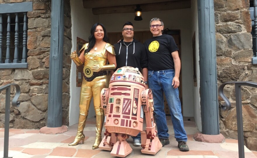Geri Hongeva (left), who voiced C-3PO in the Navajo translation of A New Hope; artist Duane Koyawena (center); and engineer Joe Mastroianni with Hopi R2 at the Museum of Northern Arizona in Flagstaff.
