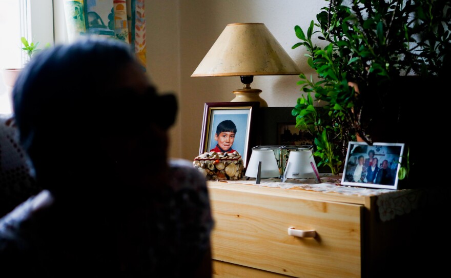 A portrait of one of Atsa Schmidt's grandsons sits on a dresser in her Nuuk living room.