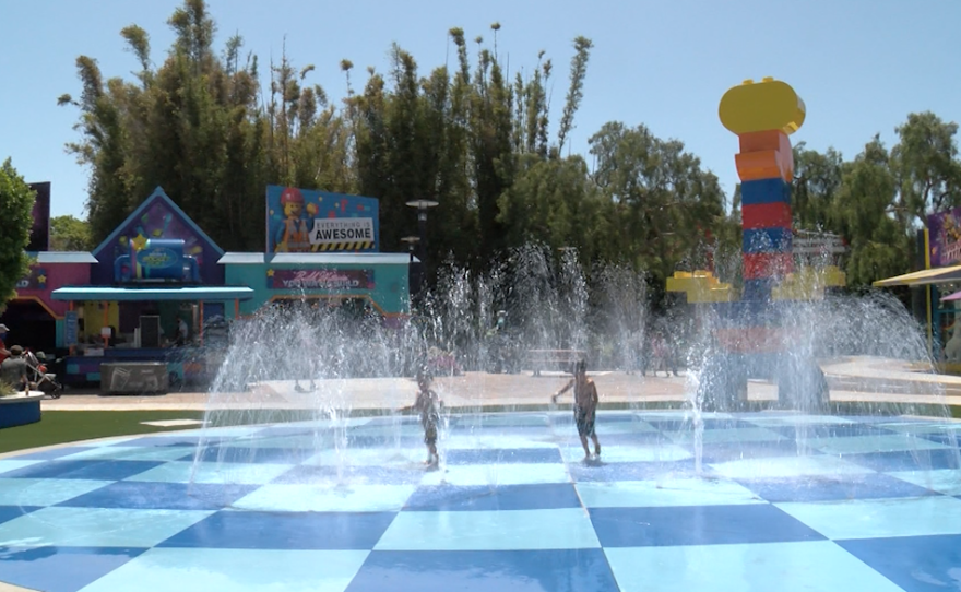 Children run through the water feature at LEGOLAND California Resort's LEGO MOVIE WORLD in Carlsbad, CA on May 27, 2021.