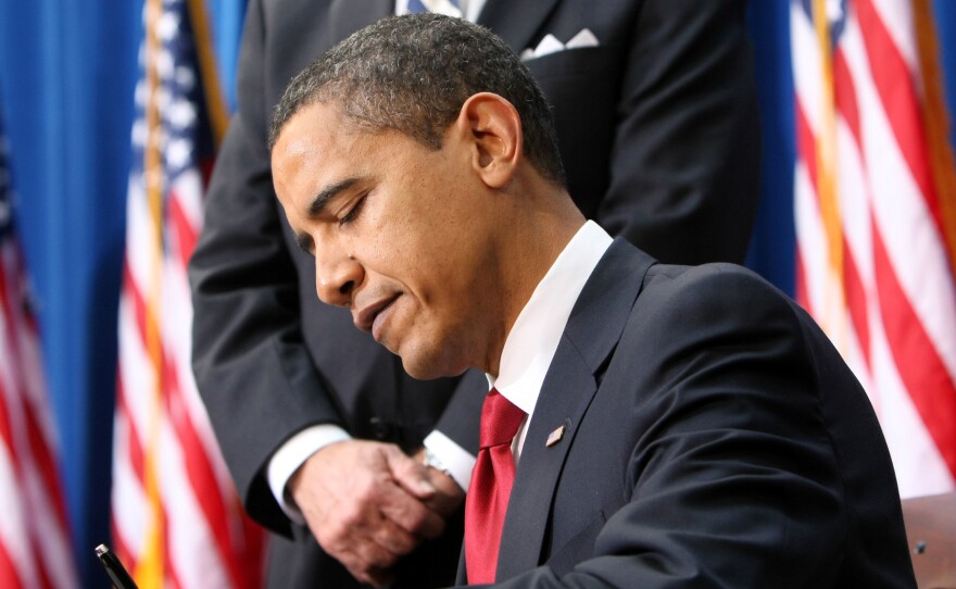 President Barack Obama signs the American Recovery and Reinvestment Act, Tuesday, Feb. 17, 2009, in Denver.