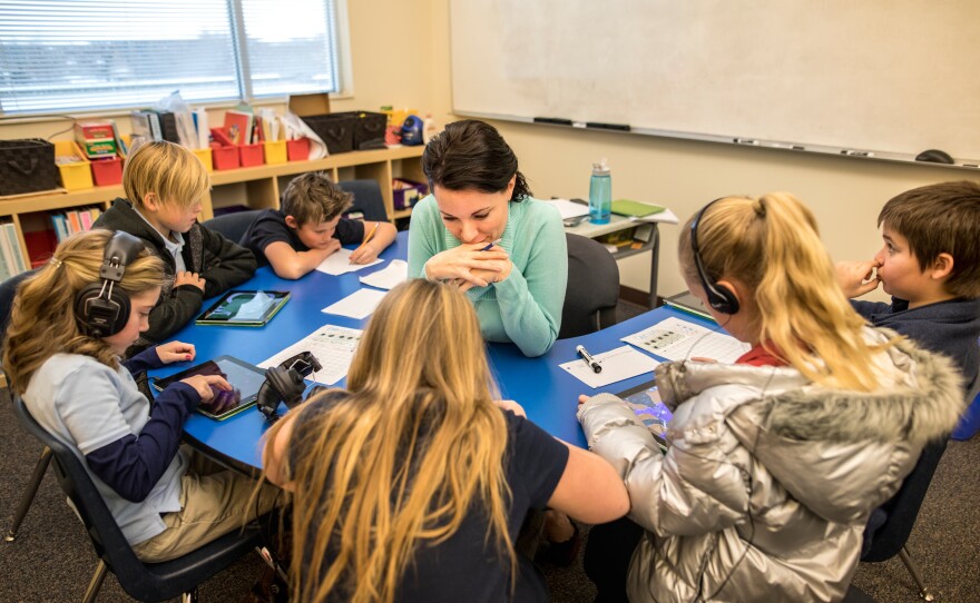 Mary Grey, a language specialist, helps out in the classroom.