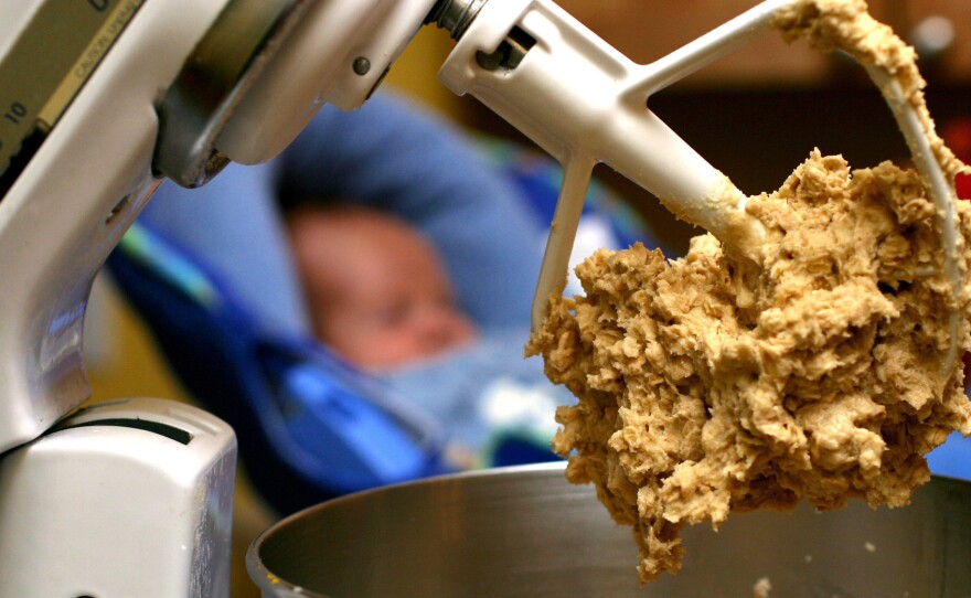Cookie dough clings to the beaters of a standing mixer. The Food and Drug Administration is warning people not to eat raw dough due to an ongoing outbreak of illnesses linked to flour tainted with E. coli.