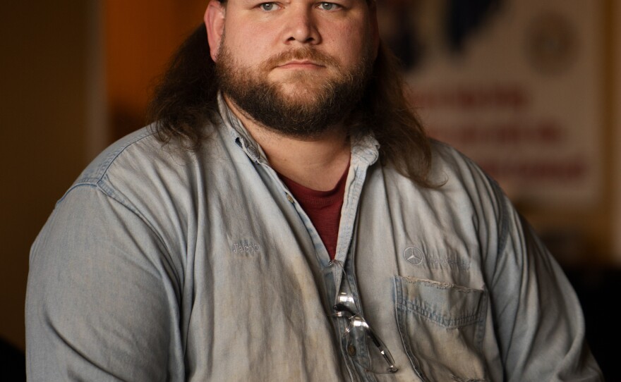 As a new, temporary employee 10 years ago, Jacob Ryan was afraid to be seen holding a pro-union flier. Nowadays, he's the guy handing out fliers, always wearing his union hat.