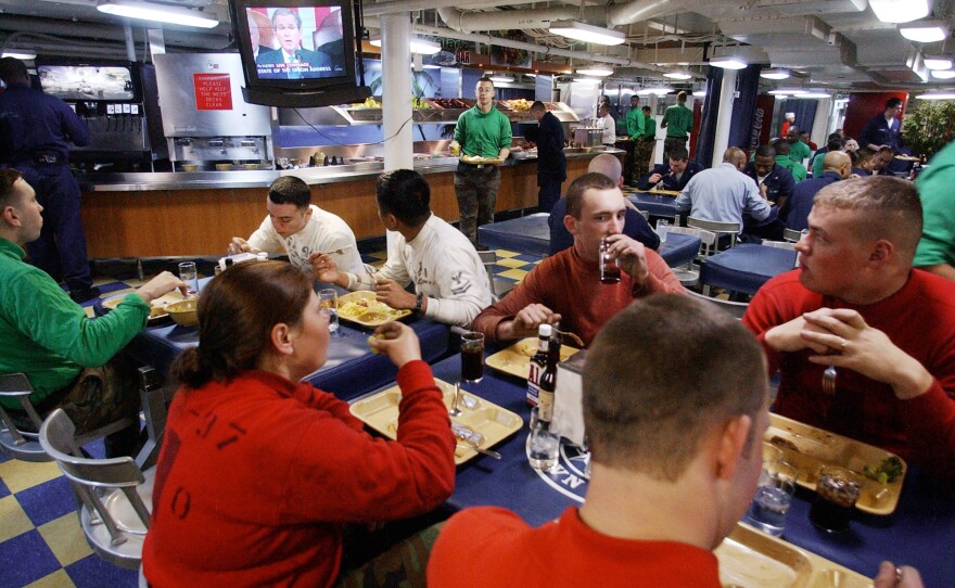 Sailors about the aircraft carrier U.S.S. Nimitz watching President George W. Bush's 2003 State of the Union speech. Not long afterwards, Bush launched an invasion of Iraq.