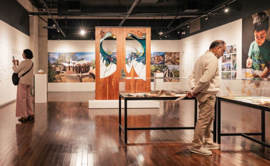 Visitors browse the exhibition, "Architecture of Jubilation: The Art and Vision of James Hubbell" at the downtown San Diego Central Library Art Gallery, on view through Aug. 4, 2024.