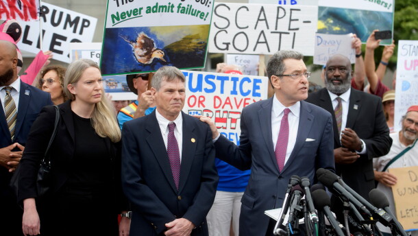 David Hearn (second from left) and his attorney Norman Eisen (right) addressed reporters after he entered his not guilty plea on July 9 in Washington, D.C.