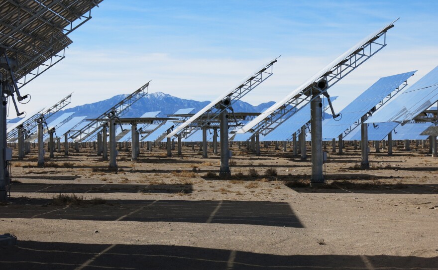 Billboard-sized mirrors arrayed in a large circle follow the sun as it moves across the sky. The heliostats, as they're known technically, direct the sun's energy to the top of a tower.