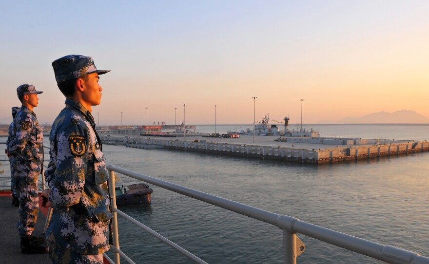 Chinese naval soldiers stand guard on China's first aircraft carrier Liaoning as it travels toward a military base in Hainan province, in this undated picture made available on Nov. 30, 2013. Tensions in the South China Sea have grown over territorial disputes between China, the Philippines, Japan and others.