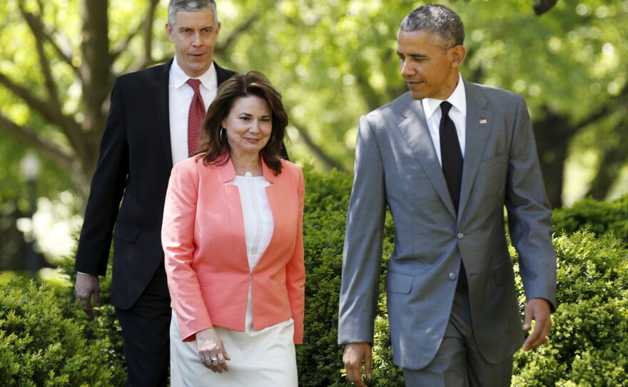 President Obama escorts 2015 Teacher of the Year winner Shanna Peeples, an English teacher at Palo Duro High School in Amarillo, Texas, into the Rose Garden on Wednesday. With them is Secretary of Education Arne Duncan.