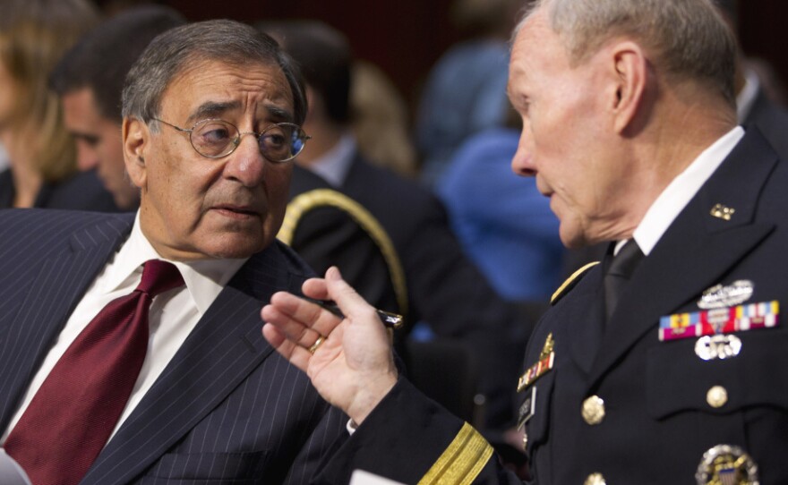Defense Secretary Leon Panetta (left) talks with Gen. Martin Dempsey, chairman of the Joint Chiefs of Staff, in Washington on Tuesday. The pair testified before the Senate Armed Services Committee hearing on security issues relating to Iraq.