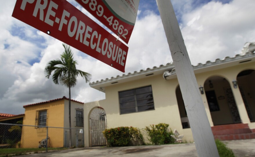 A pre-foreclosure sign hangs in front of a home in Miami.