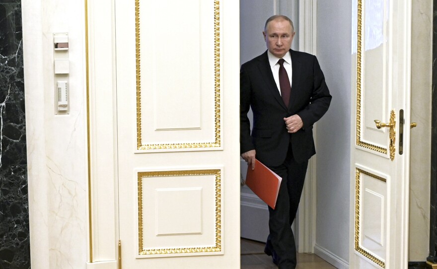 Russian President Vladimir Putin enters a hall to chair a Security Council meeting in Moscow, Russia on Friday.