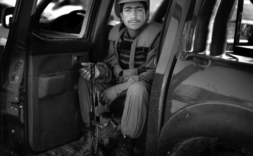 An Afghan policeman sits in the backseat of his truck in Lashkar Gah in Helmand province. Members of the Afghan National Police are four times more likely to be killed in the line of duty than the soldiers in the Afghan National Army because they are on the front lines in their local areas everyday.