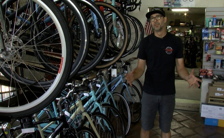 Adams Avenue Bicycles Owner Chuck Cofer speaks in his shop on August 5, 2021.