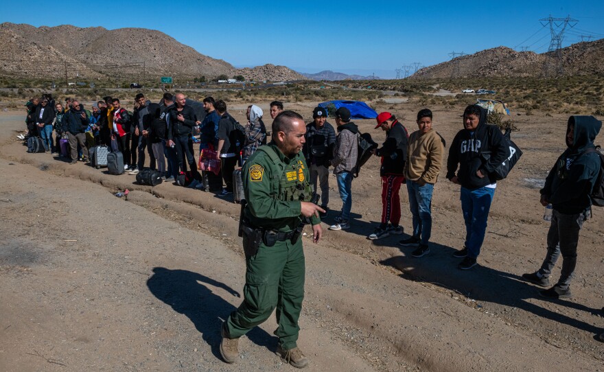 On this day, U.S. Border Patrol tells families with children to line up. They are soon taken away in a van.
