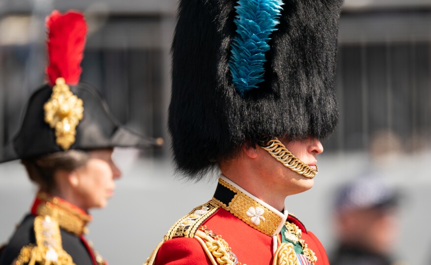 Prince William, Duke of Cambridge, in his role as Colonel of the Irish Guards, rides his horse along the Mall during the Royal Procession ahead of the Trooping the Color parade.