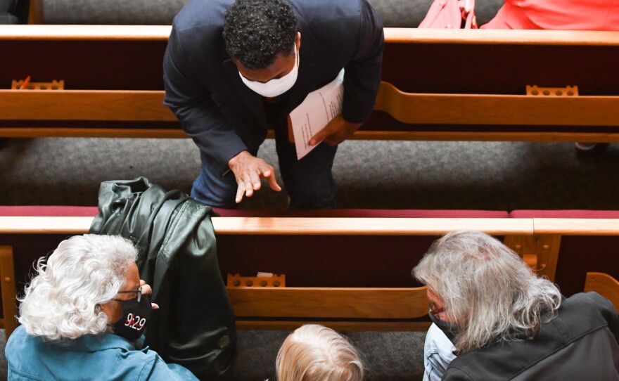 The Rev. Emanuel Cleaver III welcomes congregants to St. James United Methodist, where the COVID-19 pandemic paused in-person services for more than a year.