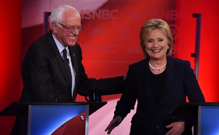 US Democratic presidential candidates Hillary Clinton (R) and Bernie Sanders smile after participating in the MSNBC Democratic Candidates Debate at the University of New Hampshire in Durham on February 4, 2016.