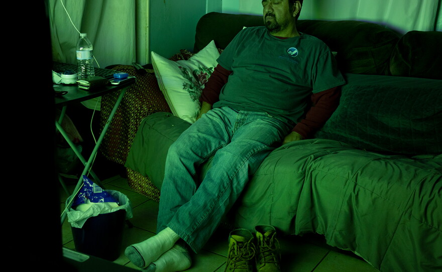 Mario Villanueva takes a nap after coming back from work in 2022.