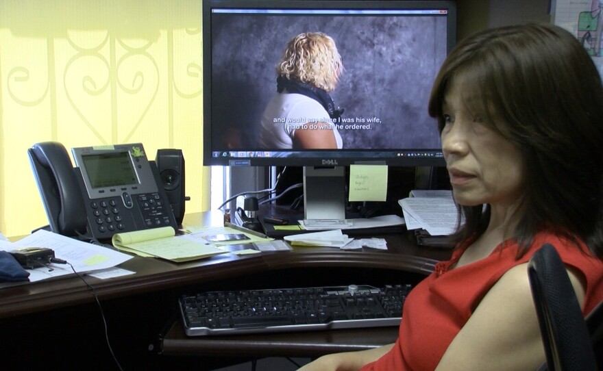 Carmen Kcomt, a legal advocate who leads an anti-human trafficking program at La Maestra Community Health Centers, plays a video showcasing a victim's testimony on her computer.