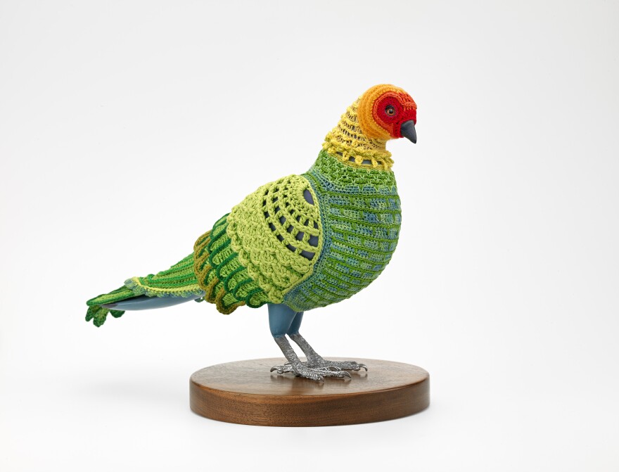 Laurel Roth Hope, <em>Biodiversity Reclamation Suit: Carolina Parakeet</em>, 2009. Suit: cotton, silk, bamboo, wool and acrylic blended yarn; mannequin: basswood, acrylic paint, gouache, glass, pewter and walnut.