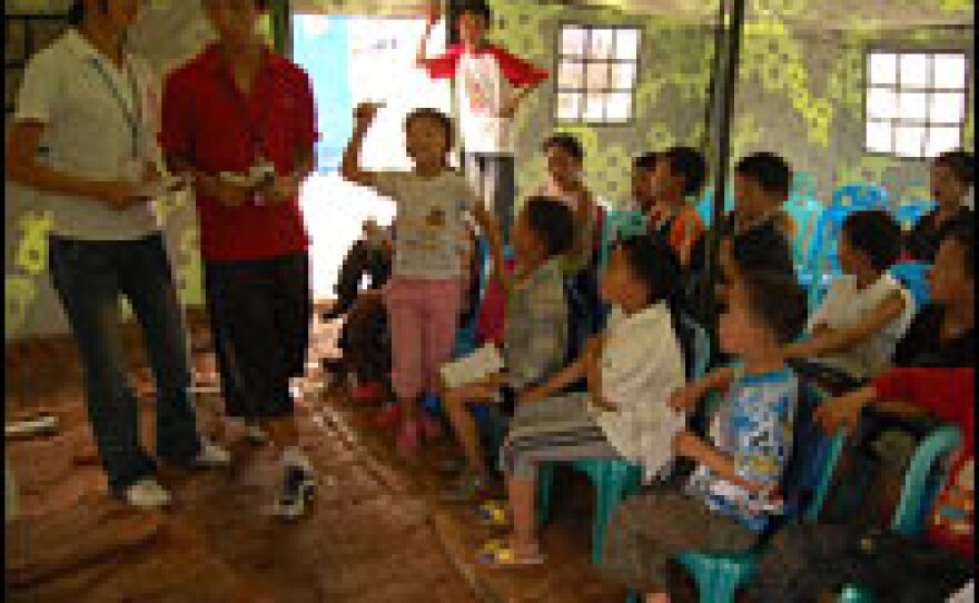High school students Li Xueyan and Li Fan lead a class of children in grades one through six.