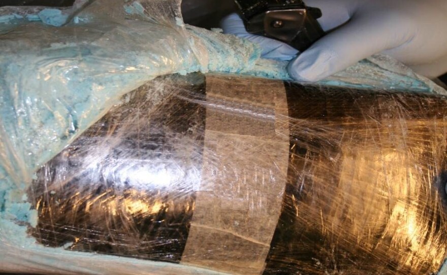 Above: One of the bundles containing narcotics seized from the scene, March 3, 2014.
