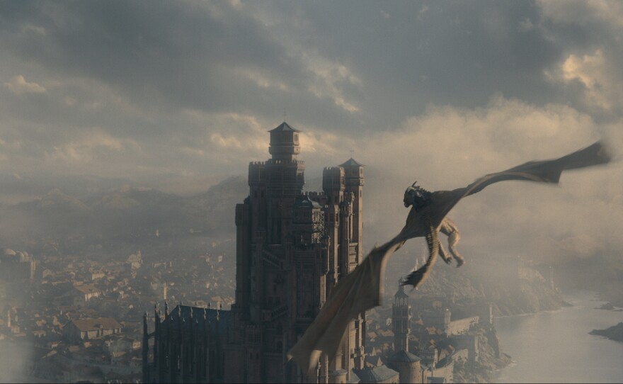 Red Keepin' it 100: A dragon flies over King's Landing on <em>House of the Dragon</em>.