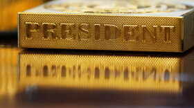 A gold-colored item embossed with the word "President" sits on the Resolute desk in the Oval Office of the White House on Nov. 10, 2025.