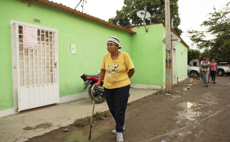 Ligia Blanco, 72, walks with a cane because of a heart operation. She comes to the kitchen to eat because of lack of affordable food in her home country of Venezuela.