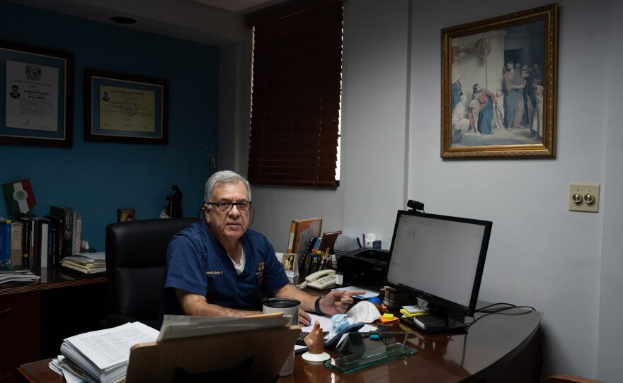 Dr. Valente Mérida browses data on his computer in his clinic in Mexicali on Aug. 7, 2024.