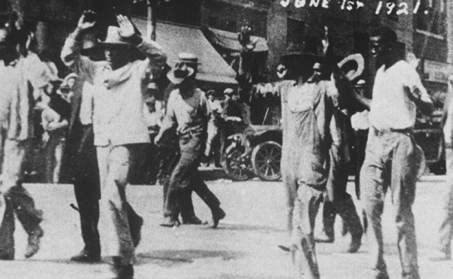 Black detainees are led to the Convention Hall following a race riot in Tulsa, Okla, June 1, 1921. The National Guard rounded up blacks by the thousands and took them to the fairgrounds, the Convention Hall and a baseball stadium where they were given food and water. By day's end, many thriving black businesses in a 35-block area had been torched.