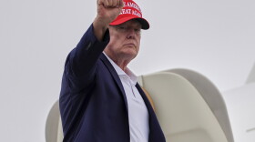 President Donald Trump gestures as he boards Air Force One at Morristown Airport, Sunday, Aug. 16, 2026, in Morristown, N.J.